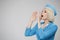 Attractive blonde flight attendant makes an announcement using her hands as a loudspeaker.