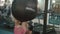 Attractive blonde sportswoman working out by boxing a punching bag at modern gym. 4k.