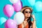 Attractive bohemian girl standing with helium balloons