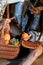 Attractive bohemian woman sitting on a floor with basket of fruits