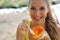 Attractive brazilian woman eating a papaya fruit outdoor