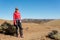 Attractive brunette posing in volcanic wasteland on sunny day.