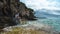 Attractive brunette sitting on a rock on the shores of the Adriatic sea , island of Vis in Croatia. Cloudy summer day, beautiful