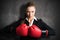 Attractive businesswoman with boxing gloves ready for a fight
