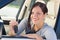 Attractive businesswoman in new car showing keys