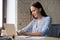 Attractive businesswoman typing message using computer at workplace