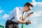 Attractive busunessman in white shirt, tie, braces and sunglasse