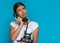 Attractive casual woman talking on a retro telephone and pondering