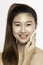 Attractive Charming Asian young woman smile and using tissue with toner for cleaning make up