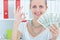 Attractive cheerful female showing many banknotes of one hundred dollars. Winning money prize conce