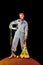 attractive cosmonaut in spacesuit with helmet and lemons in string bag posing