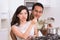 Attractive couple cooking together unpleasant meal