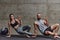 An attractive couple in the gym engaging in various stretching exercises together, showcasing their dedication to