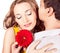 Attractive couple of lovers. Man presents flower. Valentine s d