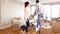 Attractive couple moving boxes into their living room