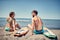 Attractive couple outdoors back view- surfers on the beach Water