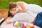 Attractive couple on romantic afternoon picnic kissing