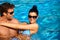 Attractive couple in swimming pool at summer