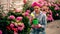 Attractive cute woman gardener in backyard cere hydrangea flowers. Summer gardening work.