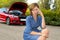 Attractive desperate and confused woman stranded on roadside with broken car engine failure crash accident calling on mobile phone