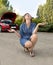 Attractive desperate and confused woman stranded on roadside with broken car engine failure crash accident calling on mobile phone
