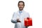 Attractive doctor holding a red gift box.