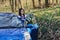 attractive driver girl looks out of open door of car