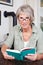 Attractive elderly woman reading a book