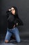 Attractive european girl with black hair and glasses posing in studio on isolated background. Style, trends, fashion concept.