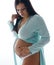 Attractive expectant mother touching her belly