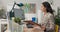 An attractive, experienced company accountant sits in office in front of a computer checking statistical data employee