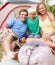 Attractive family camping. Portrait of an attractive family of three sitting in front of tent and smiling.