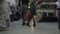 Attractive fashionable couple holding hands and shopping bags walking together in a clothing store -