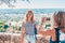 Attractive fashionable cute blonde is photographed against the background of the Mediterranean coast of France