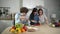 Attractive father and mother spend time together to cook fresh meal. Pedagogy.