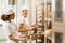 attractive female bakers putting fresh pastry on shelves