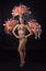 Attractive female cabaret dancer in carnival costume with red and pink feathers