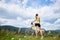 Attractive female cyclist with yellow mountain bicycle, enjoying sunny day in the mountains