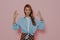 Attractive female gesturing okay sign on pink background