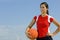 Attractive female holding a basketball