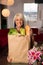 Attractive Female Homemaker Sets Grocery Bag on Counter