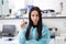 Attractive female lab worker making medical research in modern laboratory. Scientist having an idea