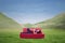 Attractive female lying on red sofa outdoor