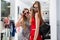 Attractive female models advertising new summer sunglasses collection in fashion store