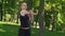 Attractive female runner stretching in park. Fit girl doing fitness exercise