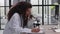 Attractive female scientist looking through a microscope