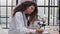 Attractive female scientist looking through a microscope