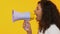 Attractive female shouting megaphone, breaking news, loudspeaker announcement