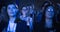 Attractive Female Sitting in a Dark Crowded Auditorium at a Tech Conference. Young Woman Applauding