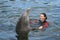 Attractive Female Teenager Swimming with a Dolphin